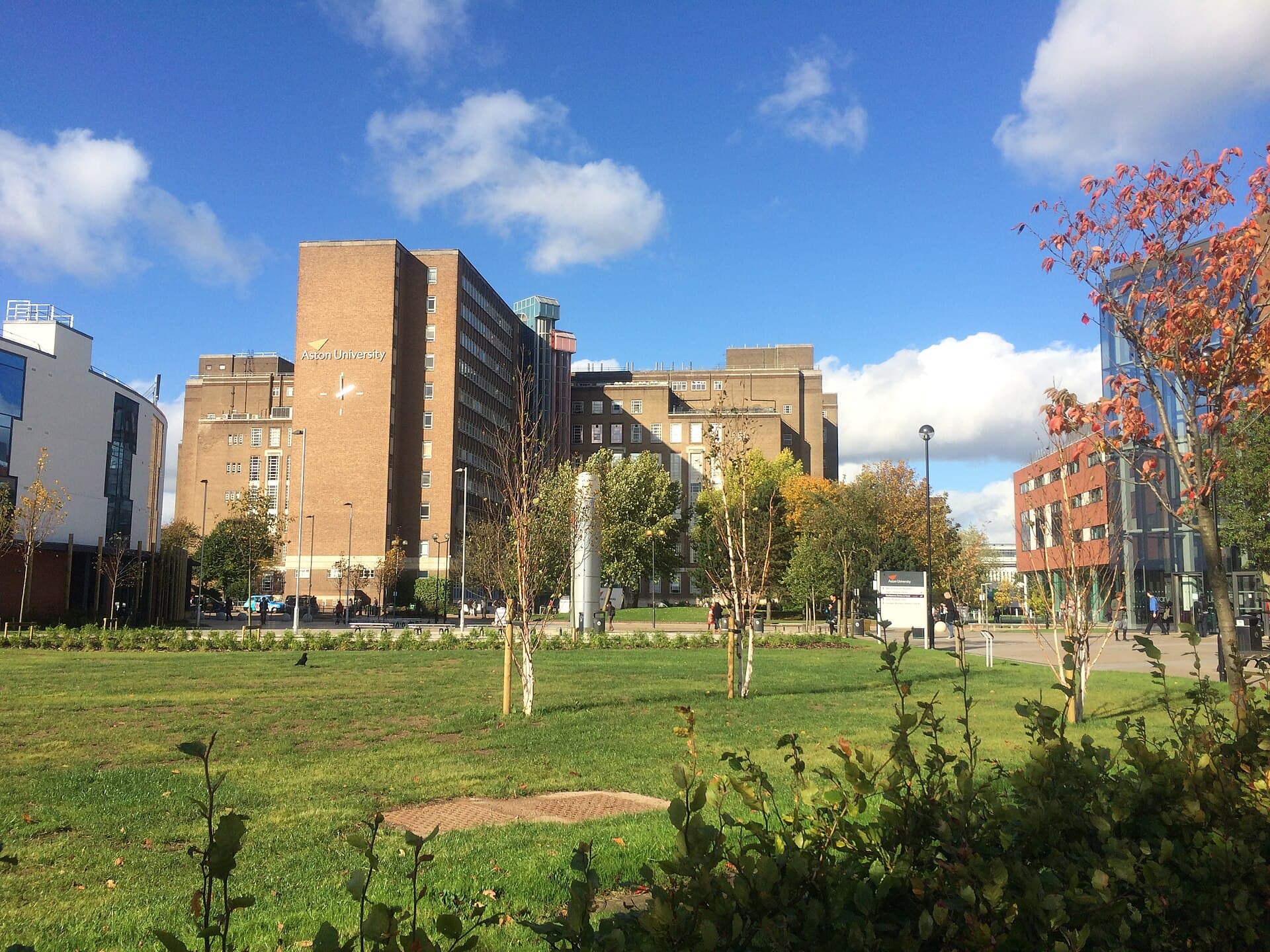 Aston University's main building with its name on the façade, above the green at the centre of the city campus