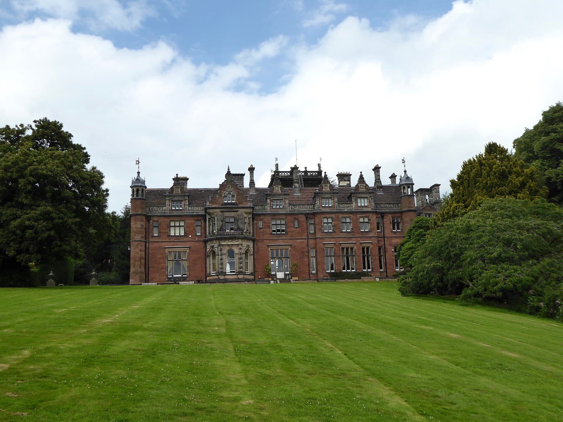 The red-brick Victorian frontage of Keele Hall above the lawn at the centre of the campus
