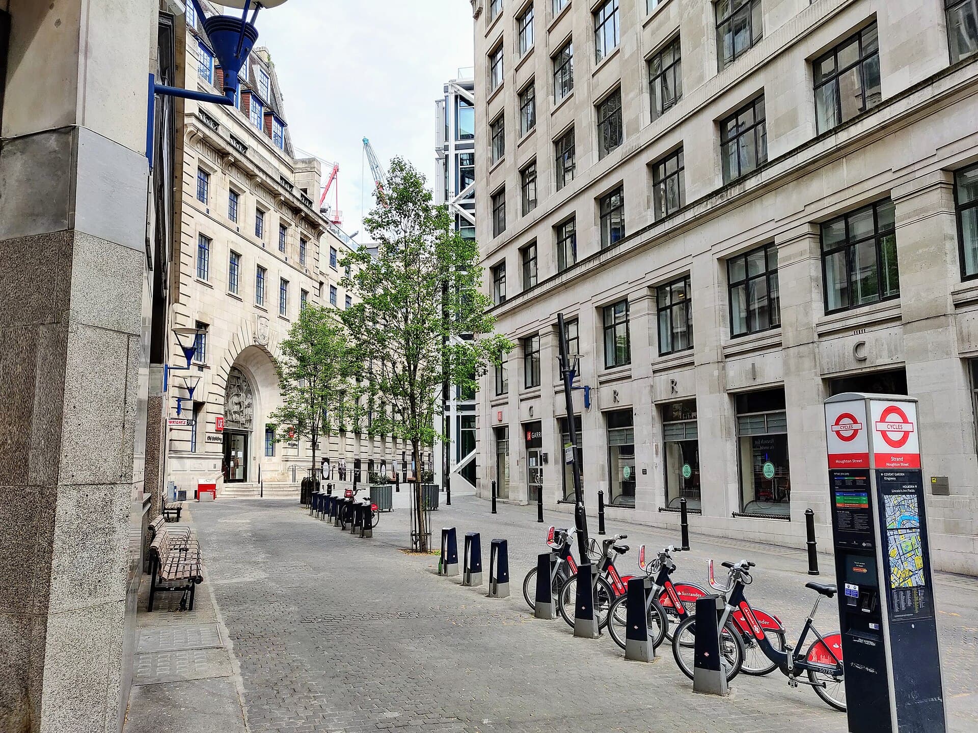 Houghton Street running through the middle of the LSE campus, with the Old Building's arch at the end
