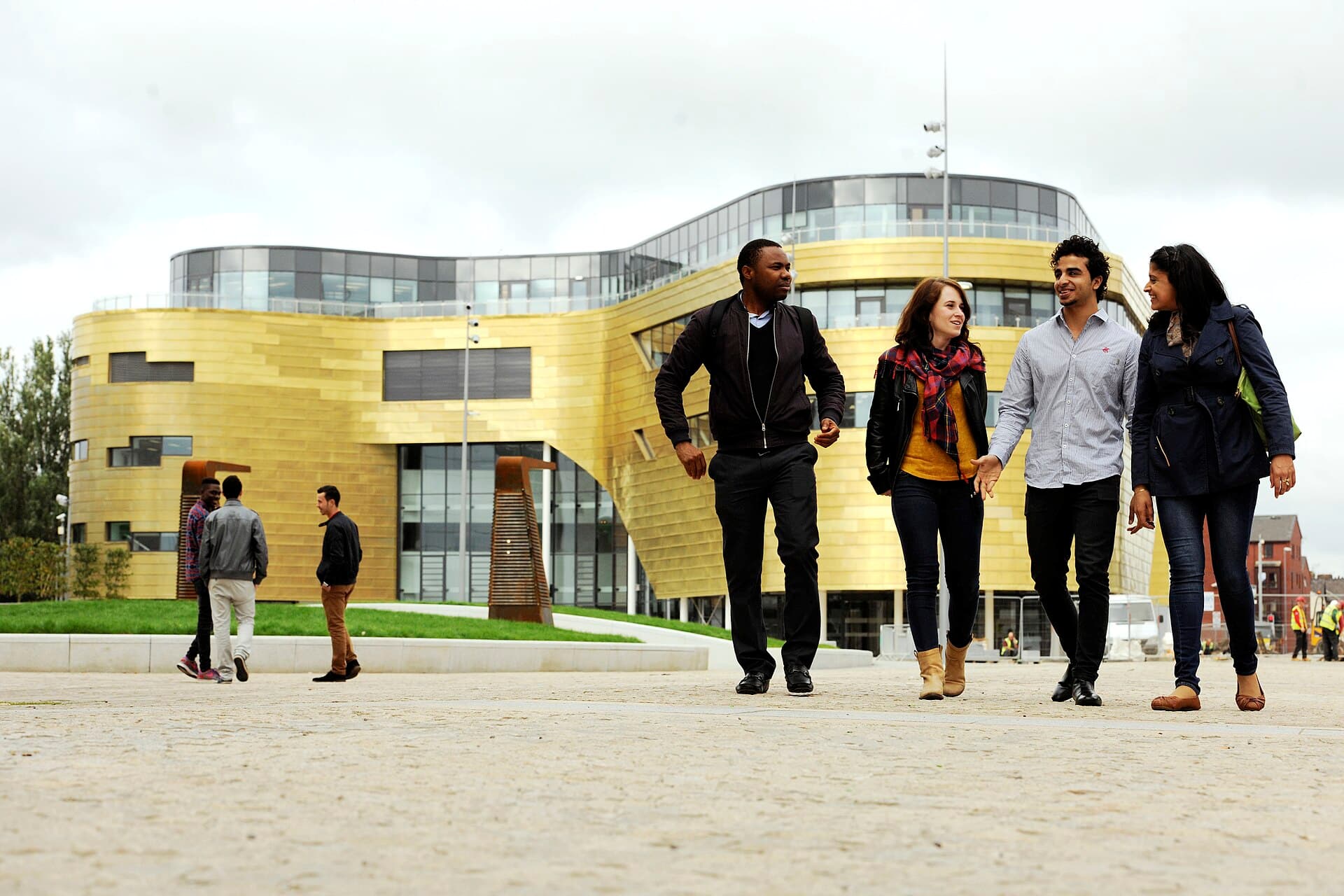 The Curve, Teesside University's gold-clad landmark teaching building, with students crossing the square in front of it