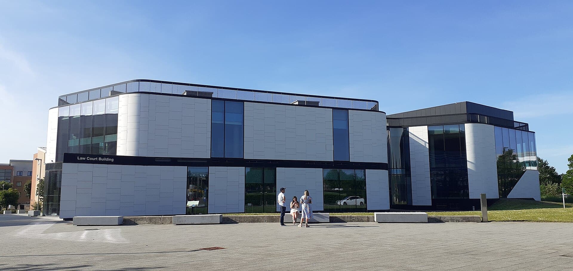 The white-panelled frontage of the University of Hertfordshire's Law Court Building above the square in front of it